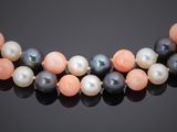 a multicolored pearl necklace on a black background
