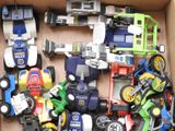 a box full of assorted toy cars and trucks