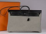 an orange and black bag sitting next to an orange box