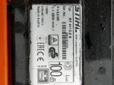 a battery that is sitting on the ground next to an orange object