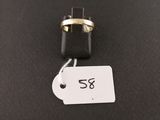 a black and gold ring on a black surface with a price tag