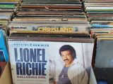 a lot of vinyl records in a box on the floor