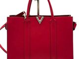 a red handbag with a metal handle on a white background