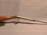 an old rifle with a wooden barrel on a white background