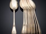 a lot of silver spoons and spoons on the table
