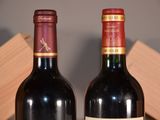 two bottles of wine sitting next to each other on a table