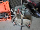 a small machine that is sitting on the floor next to a tool case