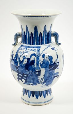 a blue and white vase with a dragon handle on it