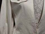 an image of a woman ' s white jacket with buttons on it