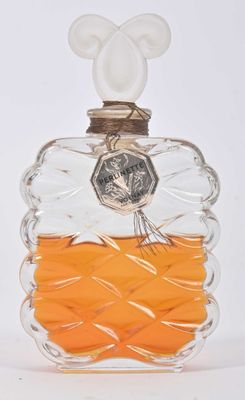 a glass bottle with an orange liquid inside of it