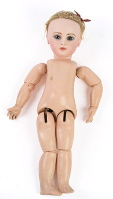 Une poupée nue est allongée sur une surface blanche.