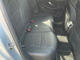 the back seats of a silver car with black leather trims