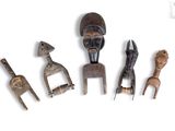 four wooden figurines of different shapes and sizes on a white surface