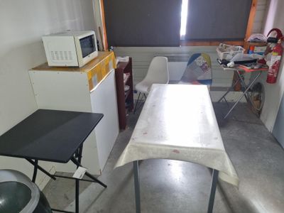 an image of a kitchen with a table and a microwave