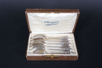 six spoons in a box on a black surface