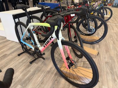 many bikes lined up on the floor in the store