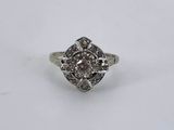 a close up of a diamond ring on a white surface