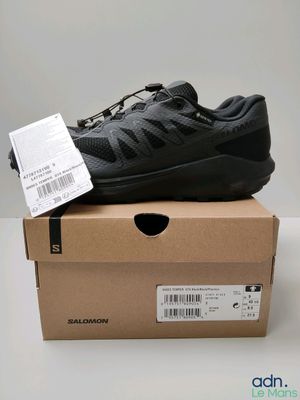 a close up of a shoe in a box on a table