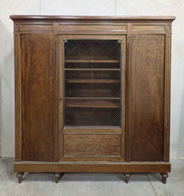 an image of a wooden cabinet with a glass door and shelves