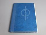 a blue book with a symbol on it sitting on a table