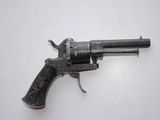 an old gun that is on a white surface