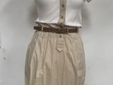 beige skirt and white shirt on a mannequin stand