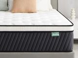 a close up of a mattress on a bed frame in a bedroom