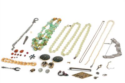 many different types of jewelry on a white surface