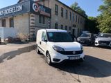 a white van that is parked in front of a building