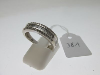 a close up of a ring on a white surface with a price tag