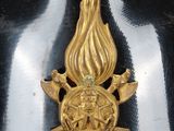 an image of a gold firefighter ' s badge on a black and white background