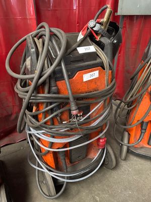 a stack of welding equipment on a cart in a garage