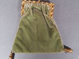 an image of a small green bag with a gold handle