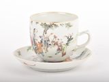 a white cup and saucer with a painting on it