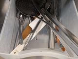 many utensils in a plastic container in the kitchen