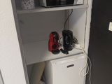 a microwave and a mini fridge in the corner of a room