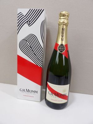 a bottle of champagne next to a box on a table