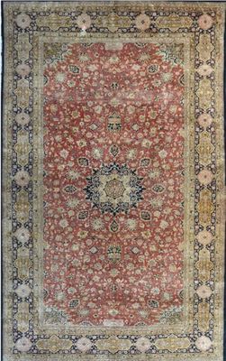 a red and gold rug with a medallion design on it