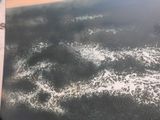 aerial view of the wing of an airplane flying over a body of water