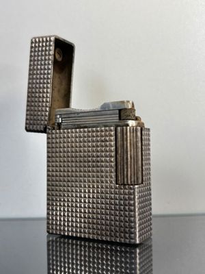 a silver lighter that is sitting on a table