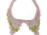 a close up of a necklace on a white background