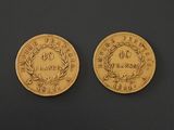 two gold coins, one of which has a crown and the other of which is a laurel