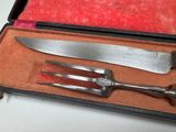a knife and fork in a case on a table