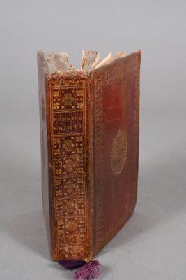 an old book with a bookmark sitting on top of it