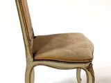 beige upholstered dining chair with nailhead trim and wooden legs