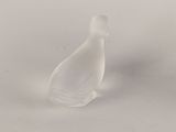 a small glass bird that is sitting on a table