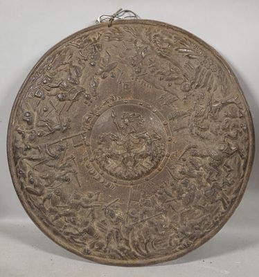 an old metal plate sitting on top of a white surface