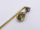 yellow gold and green tourmaline broochle pin with a diamond