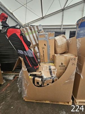 a pile of luggage sitting on top of cardboard boxes