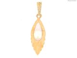 a close up of a gold pendant with a pearl in it